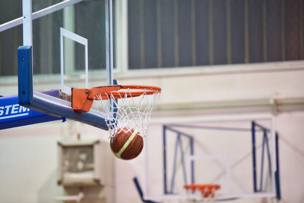 Basketball going into a basketball hoop